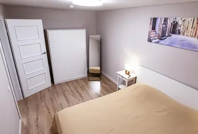 a small bedroom with a bed and a door at Šviesus ir jaukus butas Šiaulių centre puiki vieta poilsiui in Šiauliai