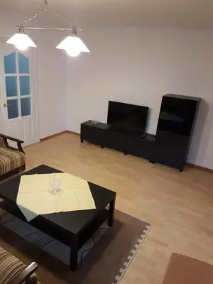 a living room with a coffee table and a couch at Apartments in Panevezys city center in Panevėžys
