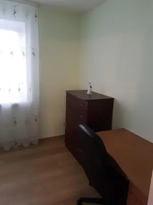 a desk and a chair in a room with a window at Apartments in Panevezys city center in Panevėžys