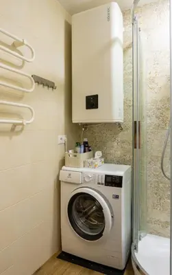 a washing machine in a bathroom with a shower at Apartamentai Tytuvėnuose in Tytuvėnai