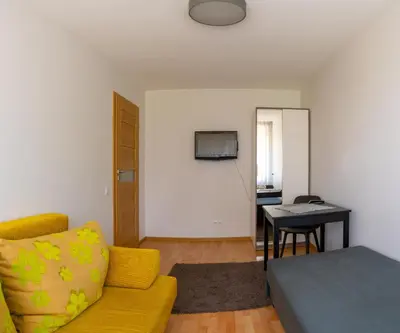 a living room with a couch and a table at Apartamentai Tytuvėnuose in Tytuvėnai