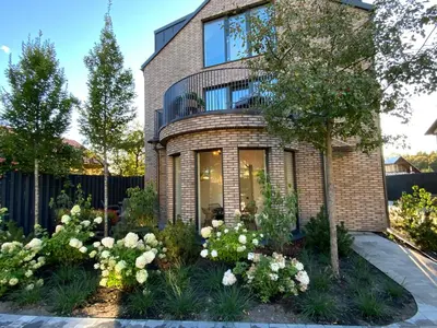a brick house with flowers in front of it at Salt Garden Superior double rooms in Druskininkai