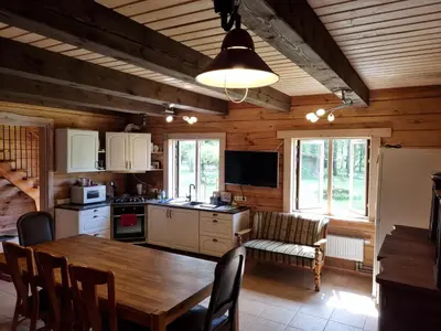 a kitchen and dining room with a wooden table at UAB LIGIS in Druzhili