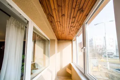 a room with a window with a wooden ceiling at Apartment Stay In in Druskininkai