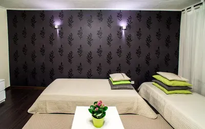 two twin beds in a room with purple walls at Apartment Stay In in Druskininkai