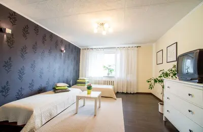 a small bedroom with a bed and a tv at Apartment Stay In in Druskininkai
