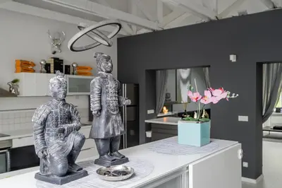 two statues sitting on a counter in a kitchen at Grey House in Vilnius