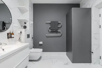 a white bathroom with a toilet and a sink at Grey House in Vilnius