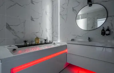 a bathroom with a tub with a red led lighting at Grey House in Vilnius