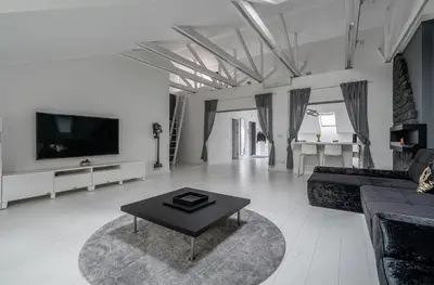 a living room with a couch and a table at Grey House in Vilnius