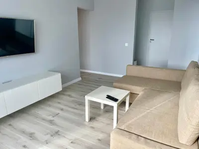 a living room with a couch and a coffee table at panoramic view and free parking in Vilnius
