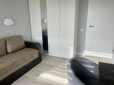 a living room with a couch and a chair at panoramic view and free parking in Vilnius
