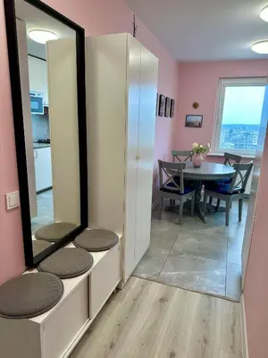 a dining room with a mirror and a table at panoramic view and free parking in Vilnius