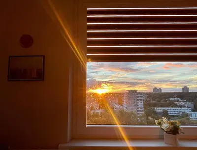 a window with a view of a sunset in a city at panoramic view and free parking in Vilnius