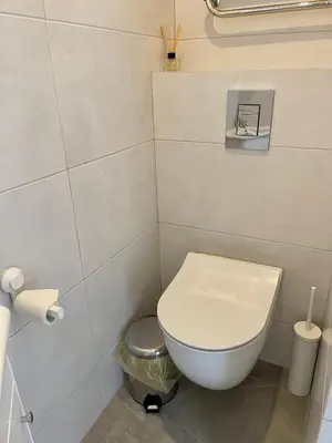 a small bathroom with a white toilet in a room at panoramic view and free parking in Vilnius
