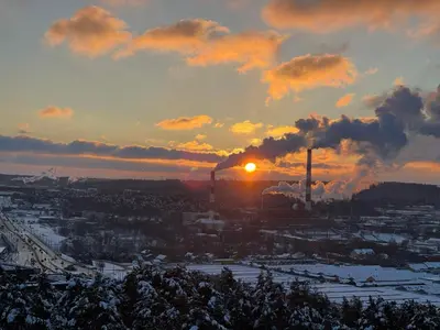 a sunset over a city with a factory at panoramic view and free parking in Vilnius