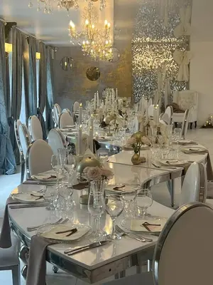 a large dining room with white tables and chairs at Vila Forest Resort in Kvietkučiai