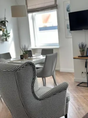a living room with two chairs and a table at Butas pačiame Šiaulių miesto centre in Šiauliai