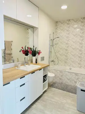 a bathroom with a sink and a toilet and a shower at Butas pačiame Šiaulių miesto centre in Šiauliai