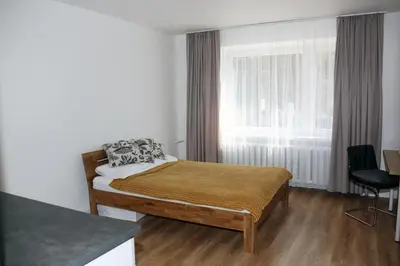 a small bedroom with a bed and a window at Naujai suremontuotas butas miesto centre. in Visaginas