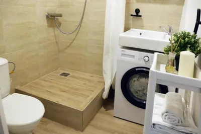a bathroom with a shower and a toilet and a sink at Naujai suremontuotas butas miesto centre. in Visaginas