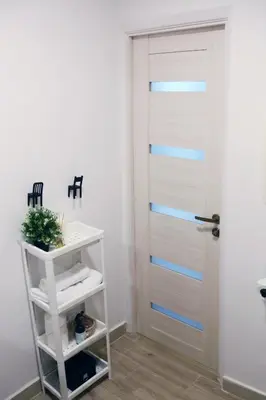 a bathroom with a door with blue stripes at Naujai suremontuotas butas miesto centre. in Visaginas
