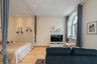 a living room with a bed and a couch at Freedom avenue apartment by Polo Apartments in Kaunas