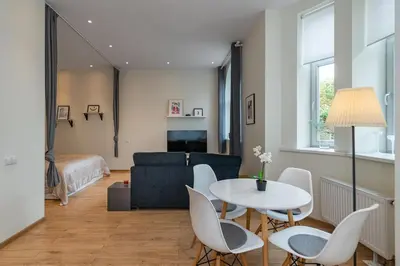 a living room with a table and chairs and a couch at Freedom avenue apartment by Polo Apartments in Kaunas