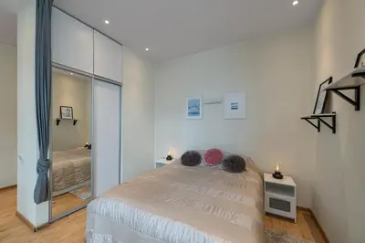 a bedroom with a bed and a large mirror at Freedom avenue apartment by Polo Apartments in Kaunas