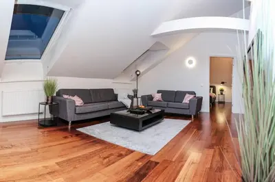 a living room with two couches and a table at #stayhere - Spacious Luxury Town Hall 3BDR Apartment in Vilnius