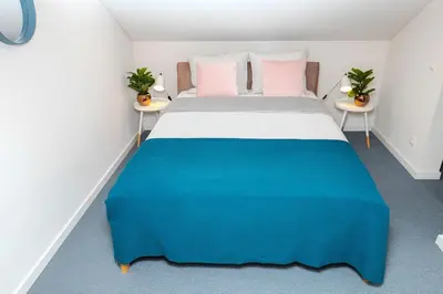 a bedroom with a large bed with two tables at #stayhere - Spacious Luxury Town Hall 3BDR Apartment in Vilnius