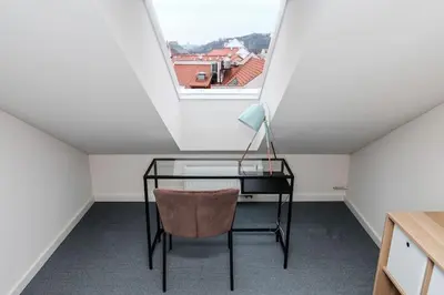 a desk and a chair in a room with a window at #stayhere - Spacious Luxury Town Hall 3BDR Apartment in Vilnius