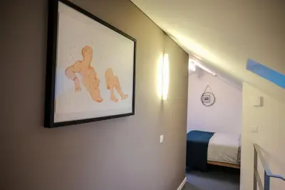a room with a painting on the wall with a bed at #stayhere - Spacious Luxury Town Hall 3BDR Apartment in Vilnius