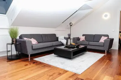 a living room with two couches and a coffee table at #stayhere - Spacious Luxury Town Hall 3BDR Apartment in Vilnius