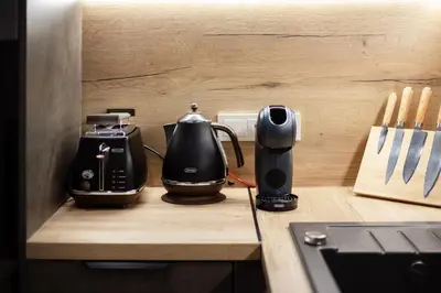 a kitchen with a coffee maker and a toaster on a counter at City Center Sanctuary Modern Business-Class Studio with Free Parking in the Heart of Vilnius in Vilnius