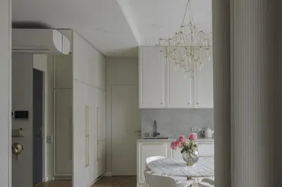 a dining room with a table and a chandelier at IVIS House - Classical Apartment with Balcony in Vilnius Old Town in Vilnius