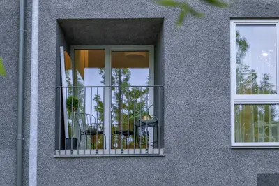 a building with a balcony with plants in it at IVIS House - Classical Apartment with Balcony in Vilnius Old Town in Vilnius