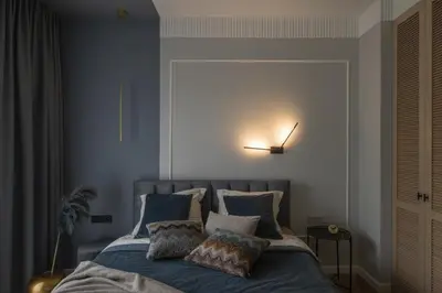 a bedroom with a bed with blue sheets and pillows at IVIS House - Classical Apartment with Balcony in Vilnius Old Town in Vilnius