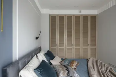 a bed with pillows on it in a room at IVIS House - Classical Apartment with Balcony in Vilnius Old Town in Vilnius