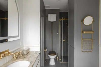 a bathroom with a toilet and a sink and a mirror at IVIS House - Classical Apartment with Balcony in Vilnius Old Town in Vilnius