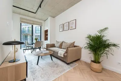 a living room with a couch and a table at #stayhere - Elegant & Light 1BDR apartment Vilnius Old Town in Vilnius