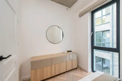 a bedroom with a mirror and a window at #stayhere - Elegant & Light 1BDR apartment Vilnius Old Town in Vilnius