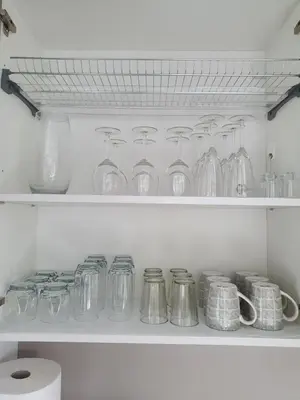 a row of glass jars sitting on a shelf at Talsa 1-bedroom apartment in city center Šiauliai in Šiauliai