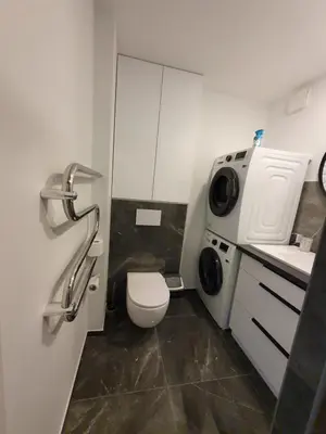 a small bathroom with a toilet and a sink at Talsa 1-bedroom apartment in city center Šiauliai in Šiauliai