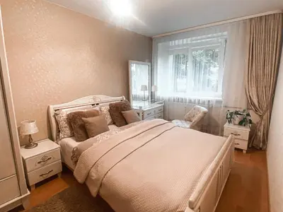 a bedroom with a white bed and a window at Apartamentai Vytauto Street III in Šiauliai