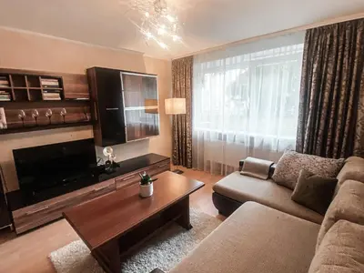 a living room with a couch and a coffee table at Apartamentai Vytauto Street III in Šiauliai