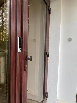a door to a house with a glass at Alanta Apartments Easy Kaunas in Kaunas