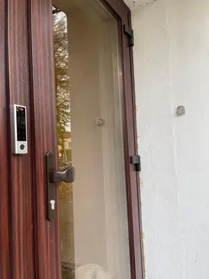 a glass door with a handle on a house at Alanta Apartments Easy Kaunas in Kaunas