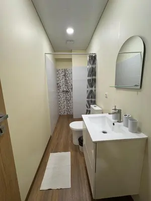 a bathroom with a white sink and a toilet at Alanta Apartments Easy Kaunas in Kaunas
