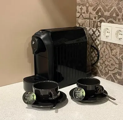 a microwave and two coffee cups on a counter at Alanta Apartments Easy Kaunas in Kaunas